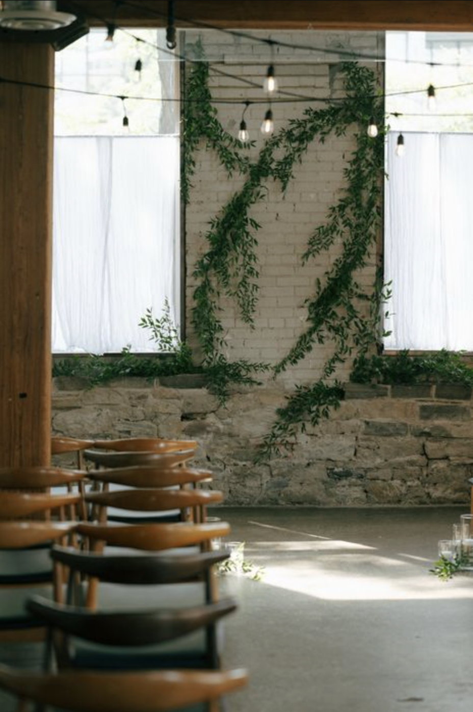 Greenery wedding installation against the brick wall at Hotel Ocho