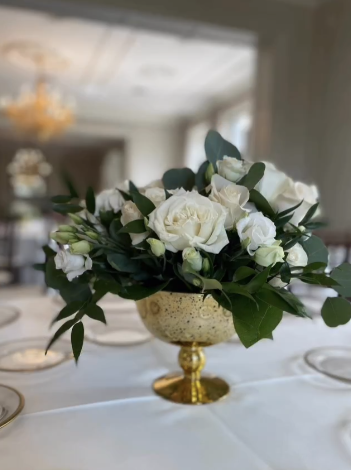 Ivory rose and lisianthus centrepiece in a gold pedestal bowl at a Graydon Hall Manor reception