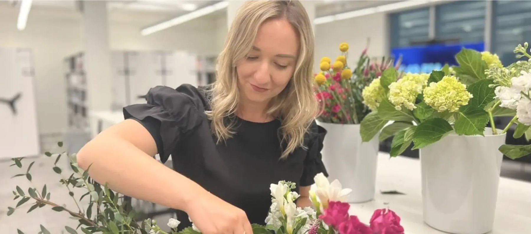 Kat arranging fresh seasonal blooms at a Blooming flower workshop