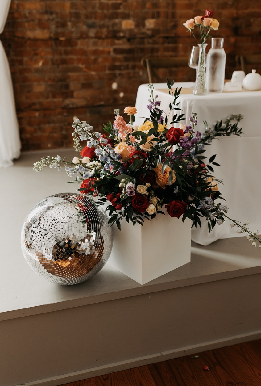 Colourful floral installation beside a disco ball at The Spice Factory