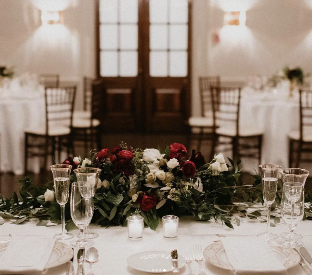 Burgundy and ivory rose garland on the head table at a Graydon Hall Manor reception