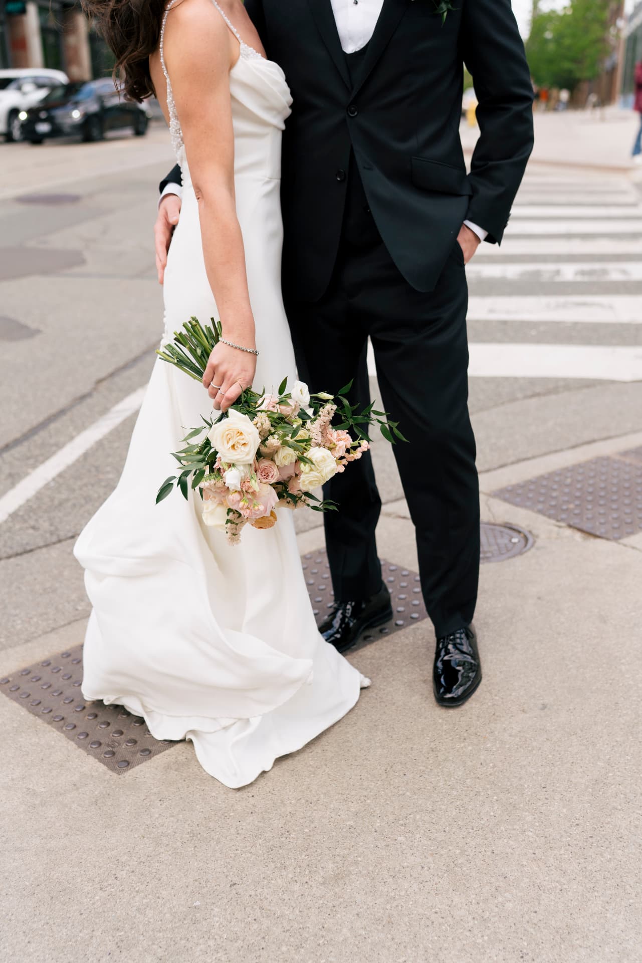 Hannah and Kyle together outside with her garden-style bridal bouquet