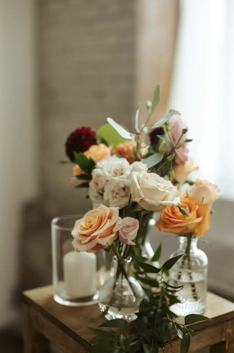 Peach, ivory and burgundy wedding centrepiece at Hotel Ocho