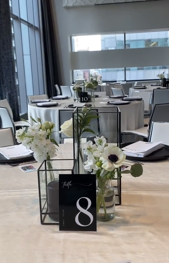 White anemone and stock bud vases with black geometric lanterns at a Malaparte reception