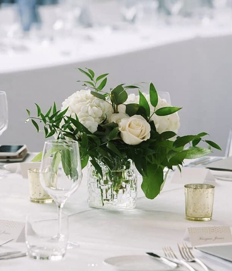Ivory rose, hydrangea and ruscus centrepiece with gold votives at Malaparte